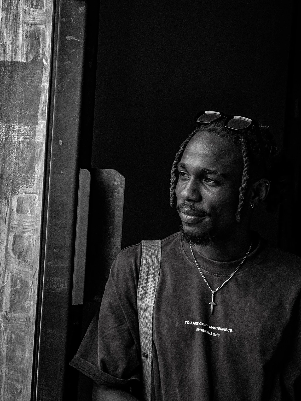 Monochrome portrait by a doorway